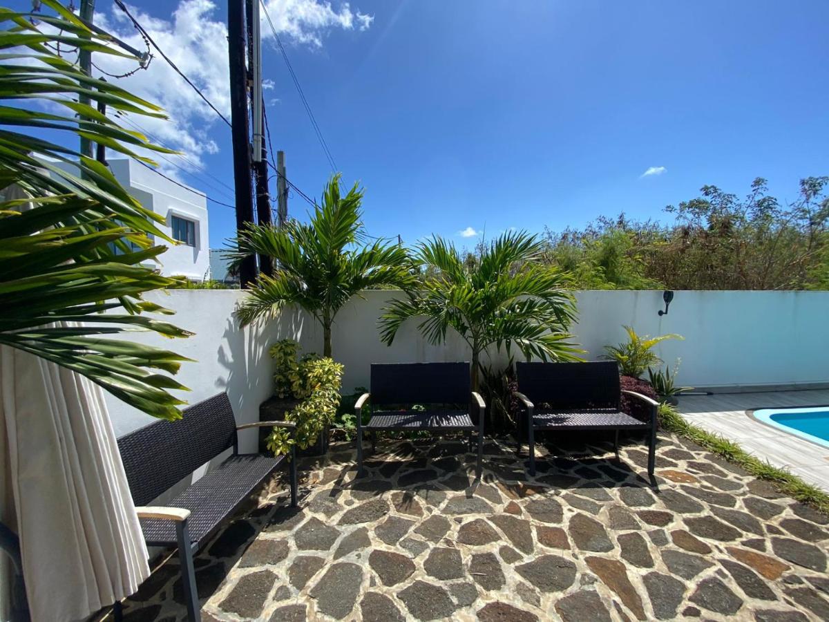 Poolside seating area at Luxora Villa Pereybere Mauritius